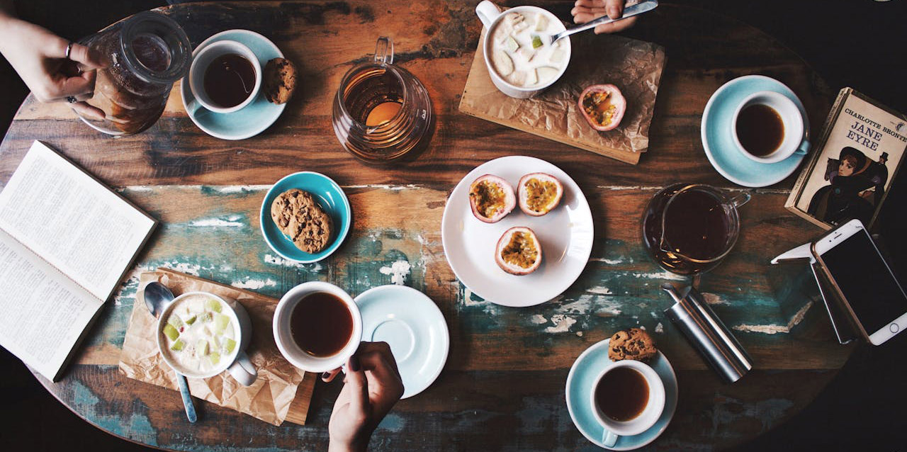 A group of friends meeting in a coffee shop. Image to represent blog post on managing social interaction